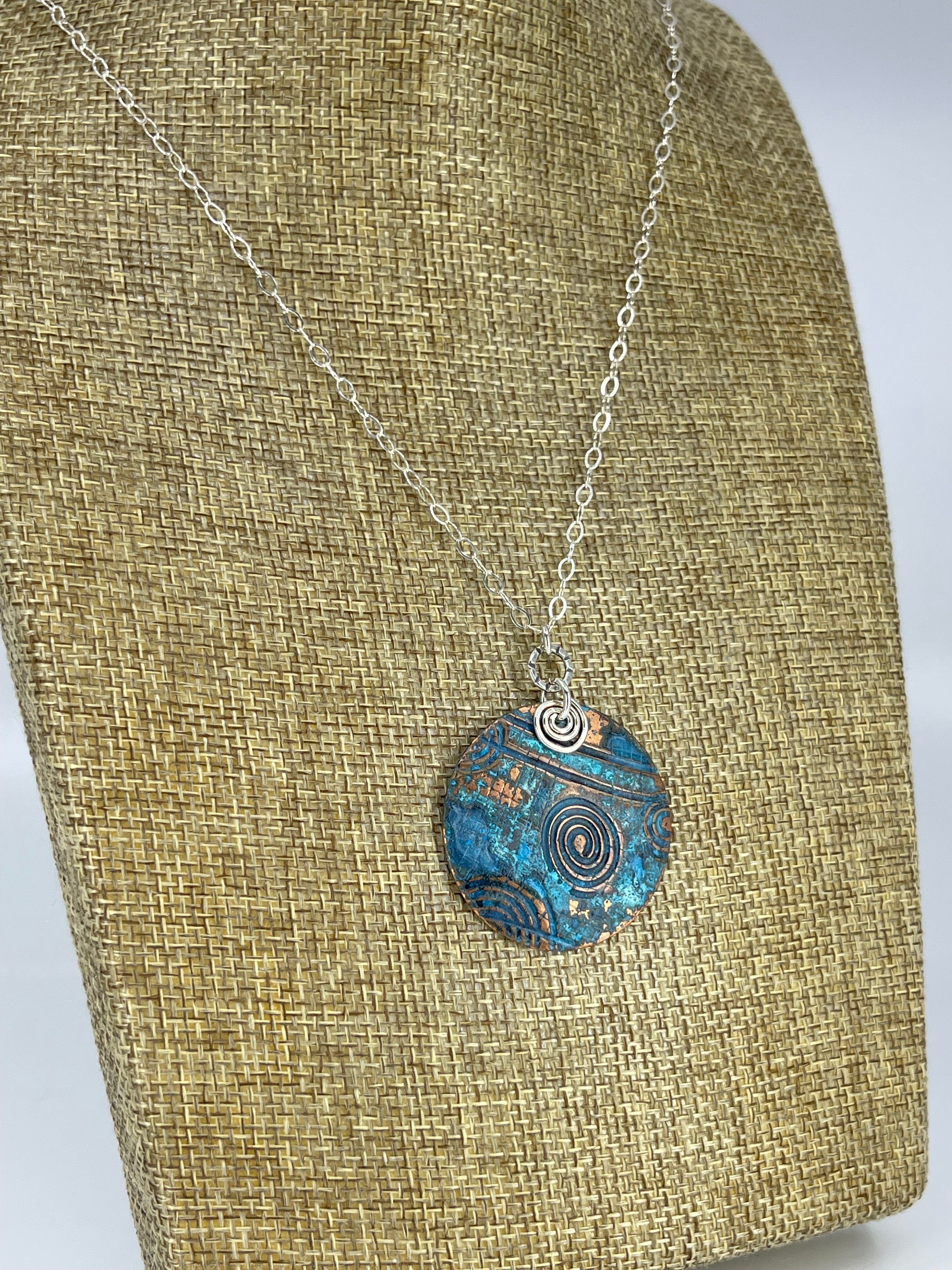 Copper blue patina necklace shown on linen display bust