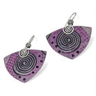 Pair of pink earrings with spiral design on a white background
