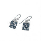Pair of silver earrings with geometric design by Kristin Christopher