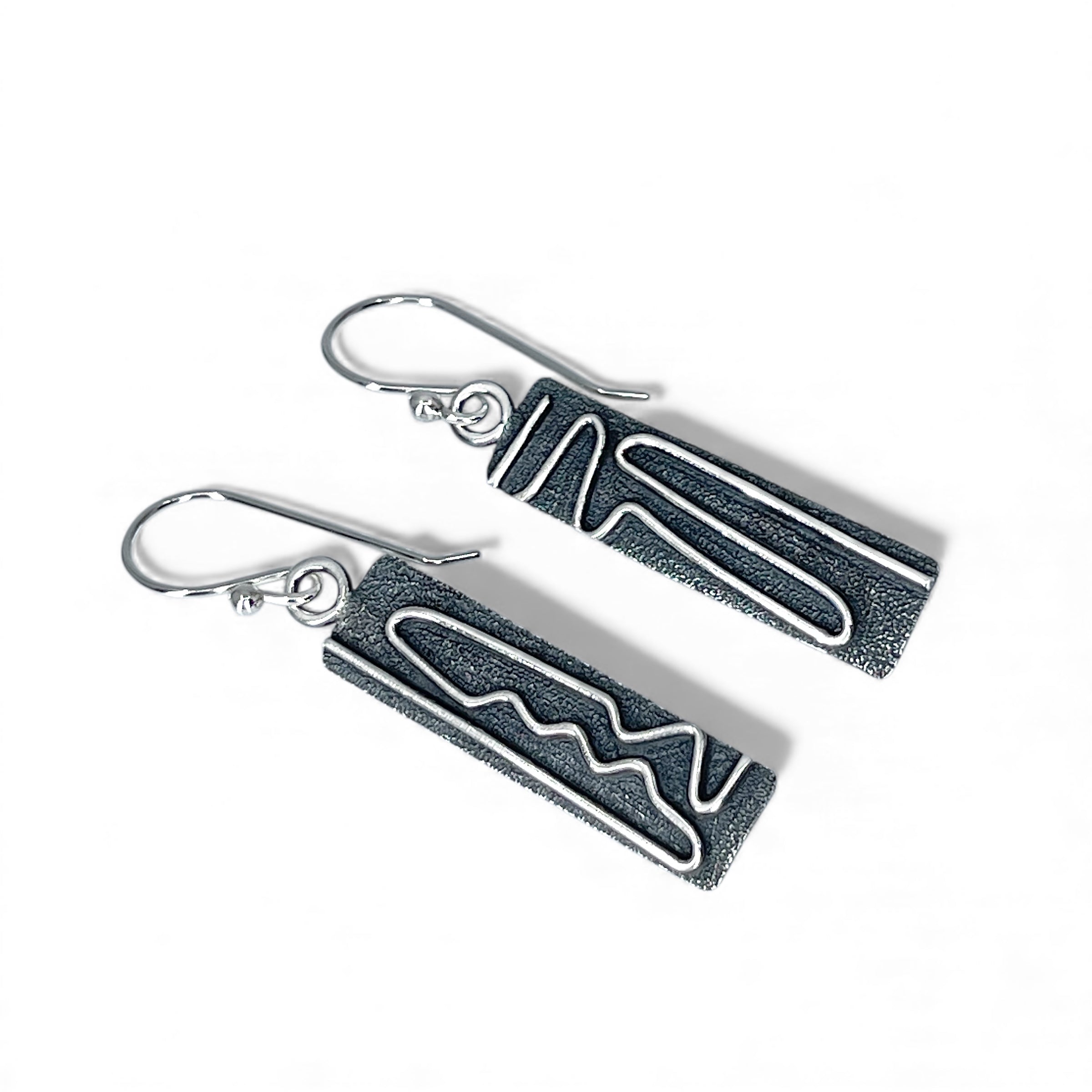 Sterling silver earrings with a geometric design on a white background