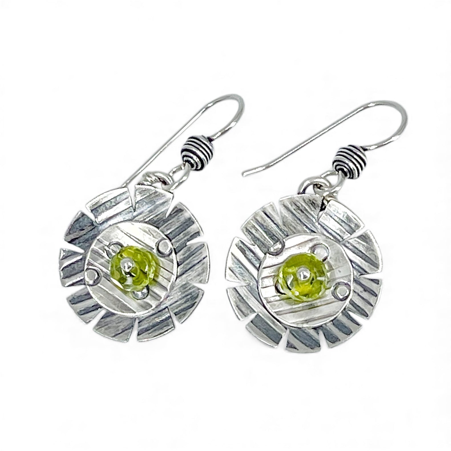 Sterling silver earrings with green peridot gemstones on a white background