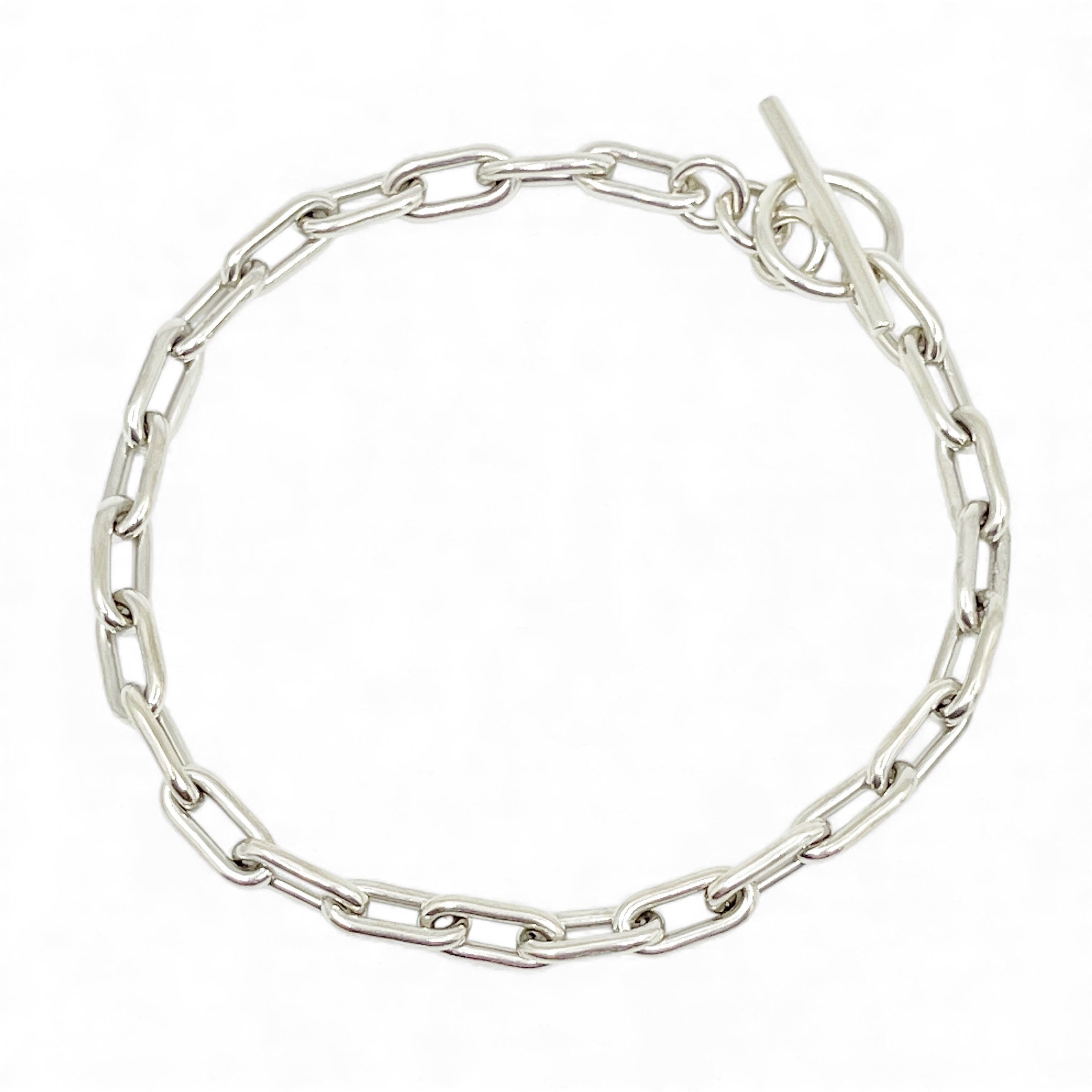 Sterling silver oval link bracelet on white background